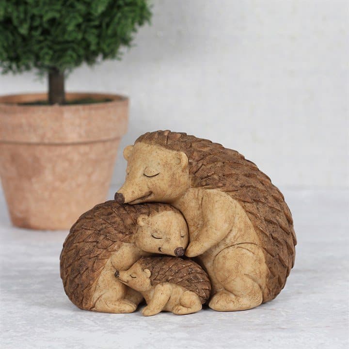 Hedgehog family ornament of two parent hedgehogs embracing their baby