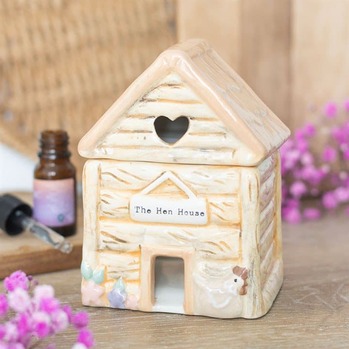 Ceramic hen house oil burner with a heart-shaped cut-out