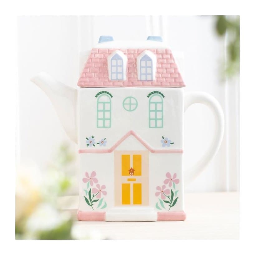 Pastel house shaped teapot styled like a storybook cottage