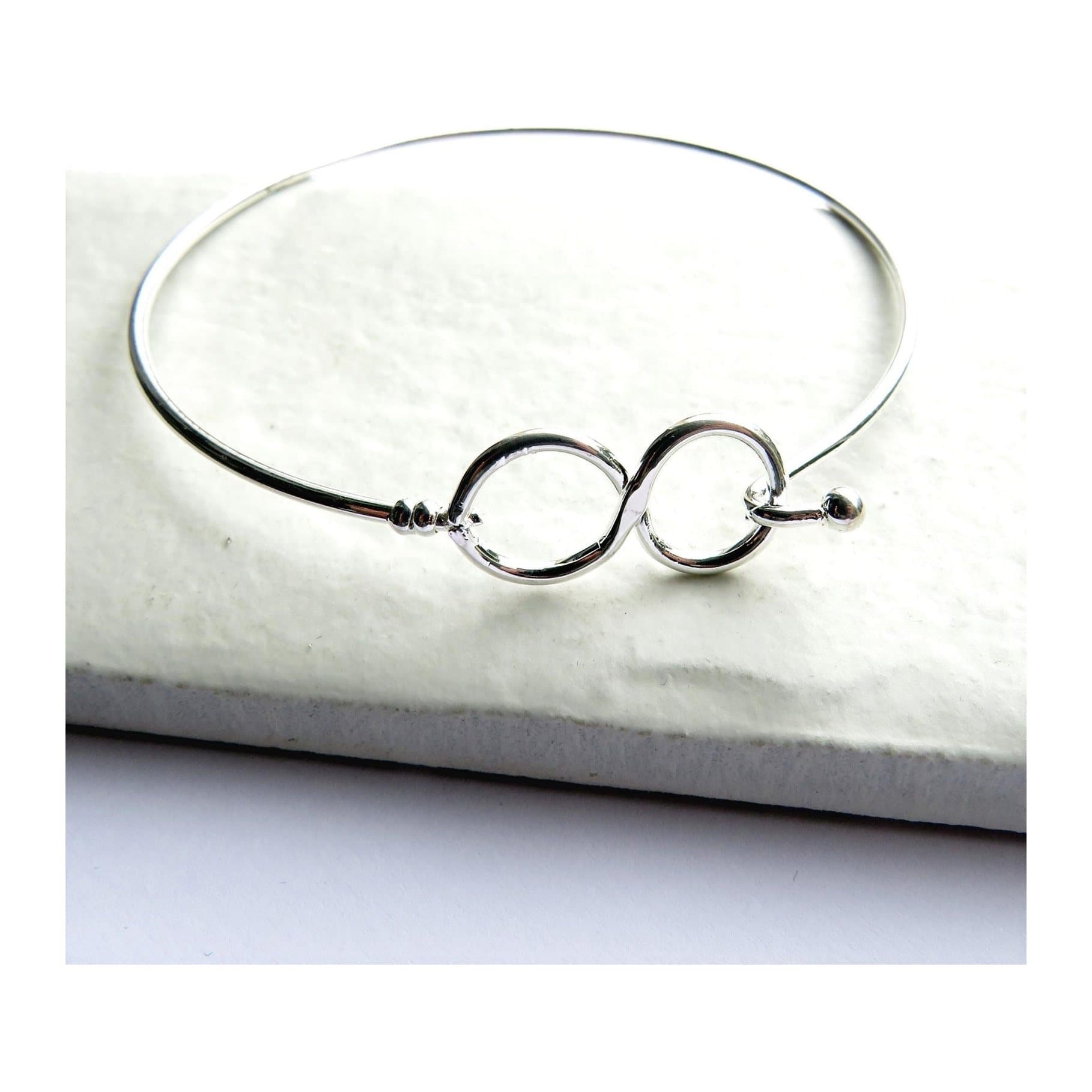 Silver-plated infinity cuff bangle with an infinity motif design