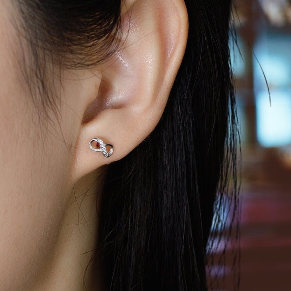 Pair of sterling silver diamante infinity stud earrings