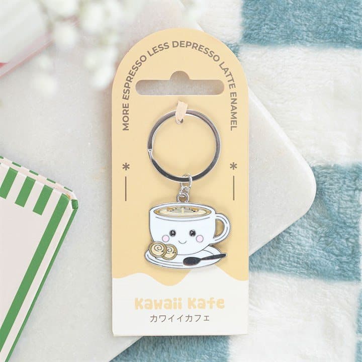 Enamel keyring of a smiling kawaii latte cup on a cardboard backing card
