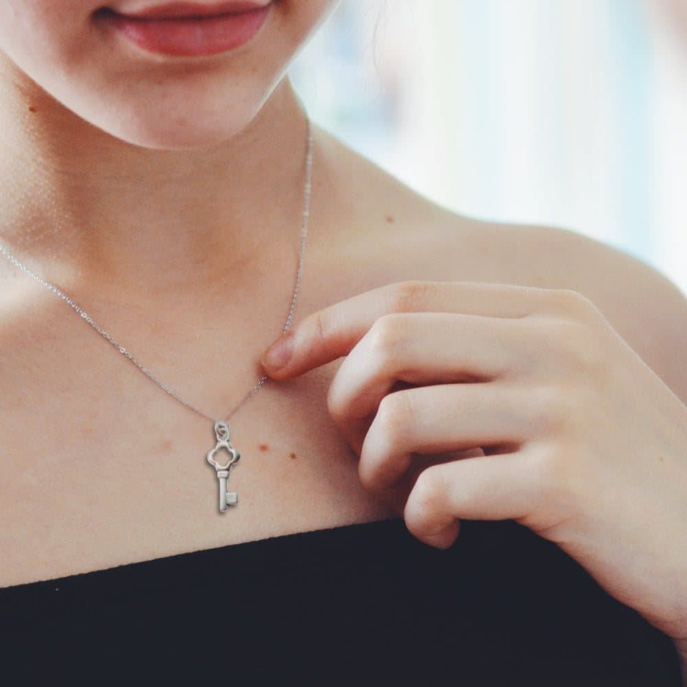 Silver key charm necklace on a chain
