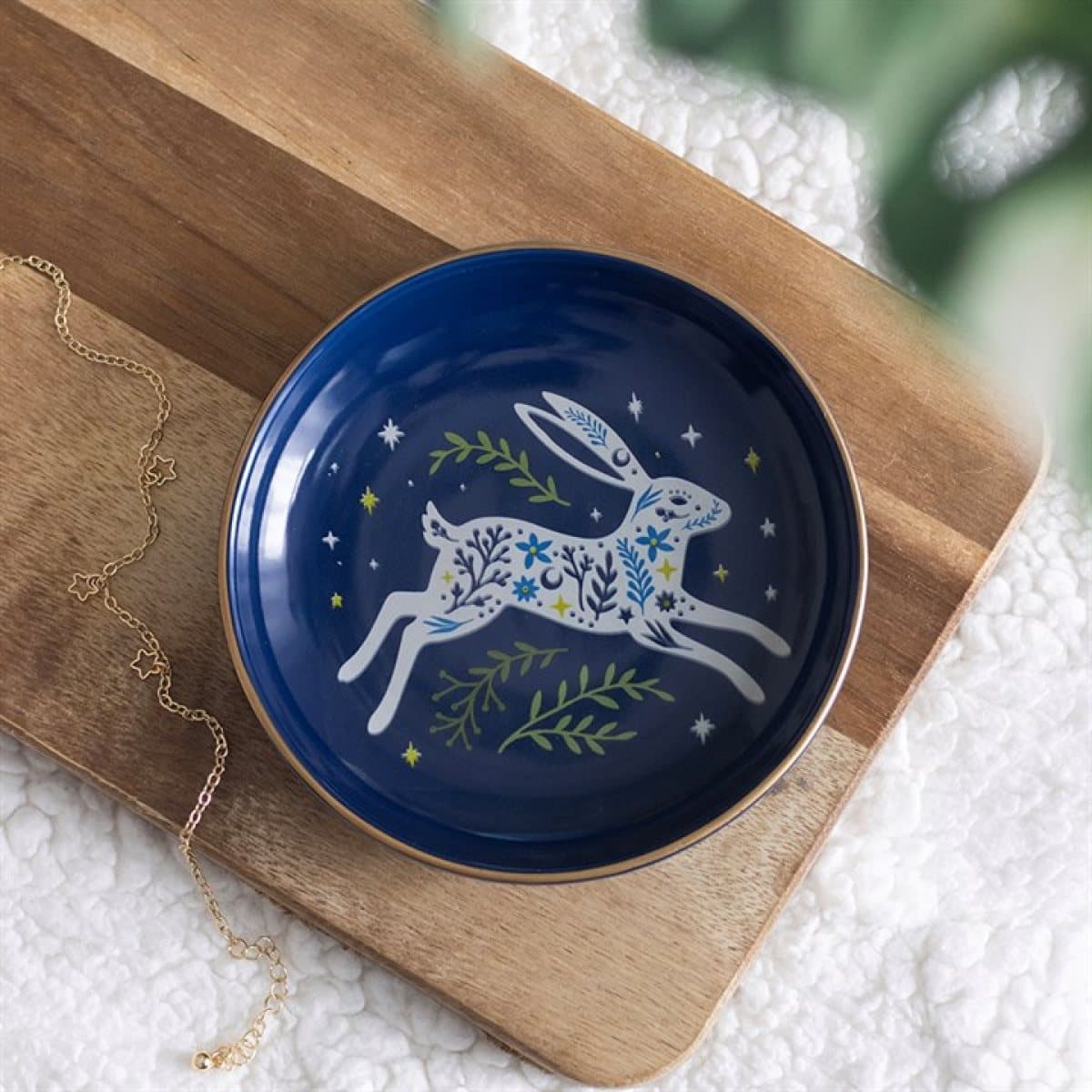 Ceramic trinket dish with a graceful hare on a deep midnight blue background