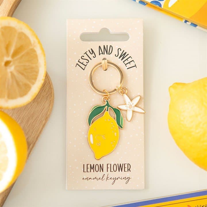 Enamel keyring with a delicate lemon flower design on a cardboard backing card