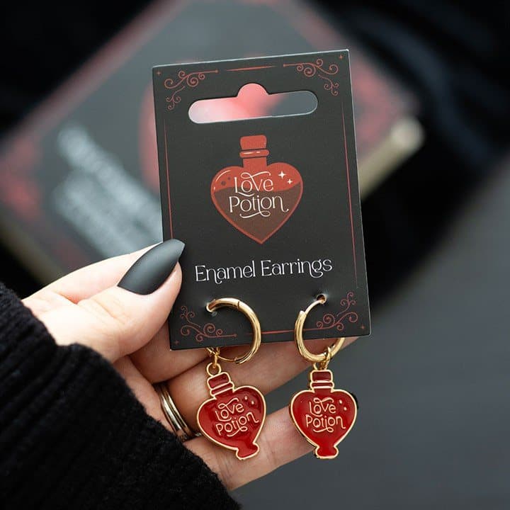 Pair of gold-toned dangle earrings with enamel love potion charms