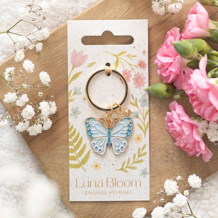 Pastel blue enamel butterfly keyring on a cardboard back