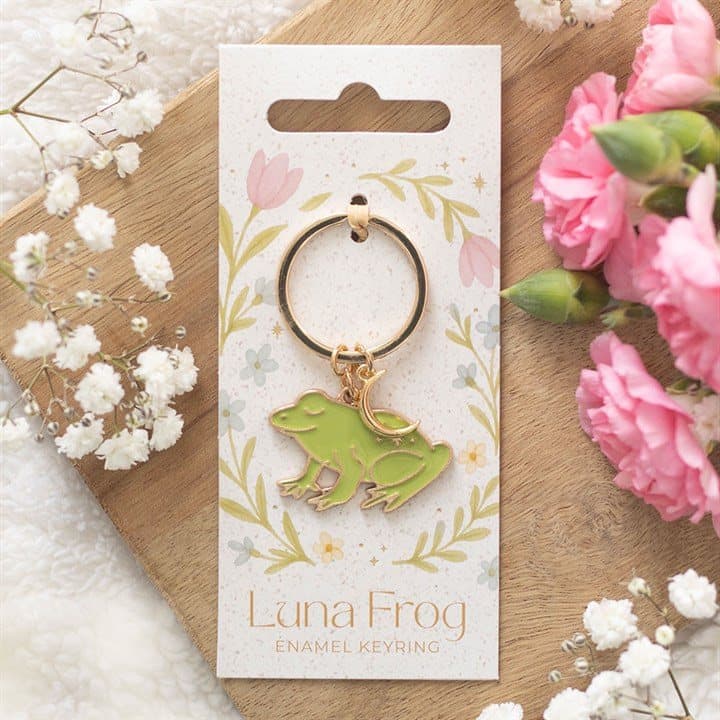 Enamel frog keyring with celestial details on a cardboard back