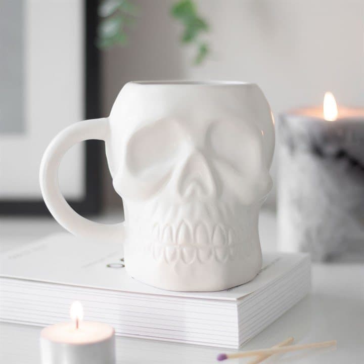 Matte white ceramic mug with a classic skull design