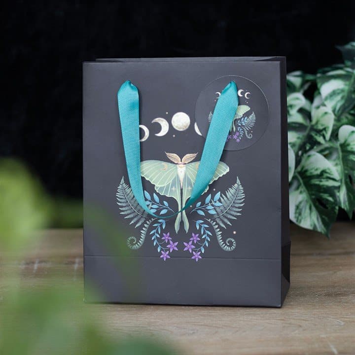 Medium paper gift bag printed with a luna moth and moon phases