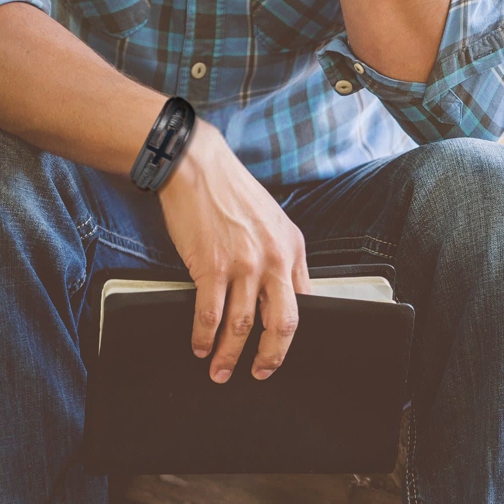 Men's black faux leather cross bracelet with a sleek cross design