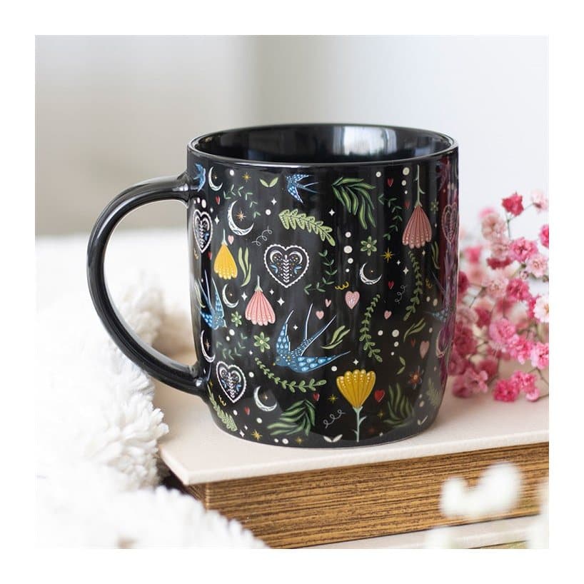 Black mug with a colourful folk flower print