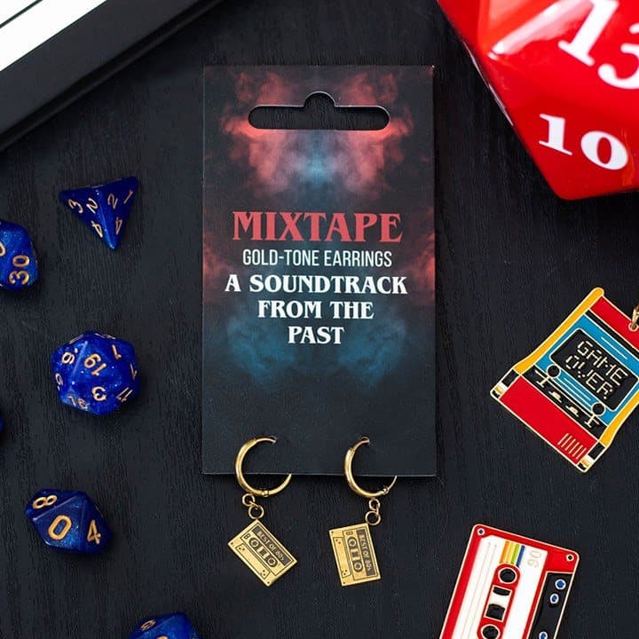 Gold-tone mixtape dangle earrings on a cardboard back