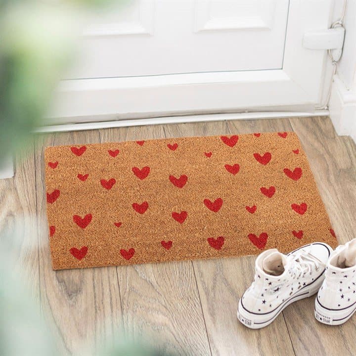 Natural coir doormat decorated with vibrant red love hearts