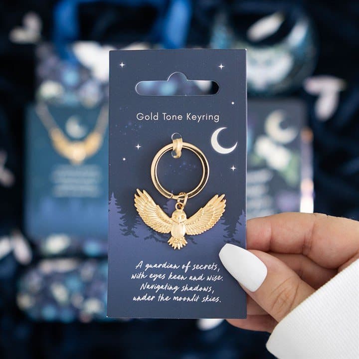 Gold-toned flying night owl keyring on a matching backing card