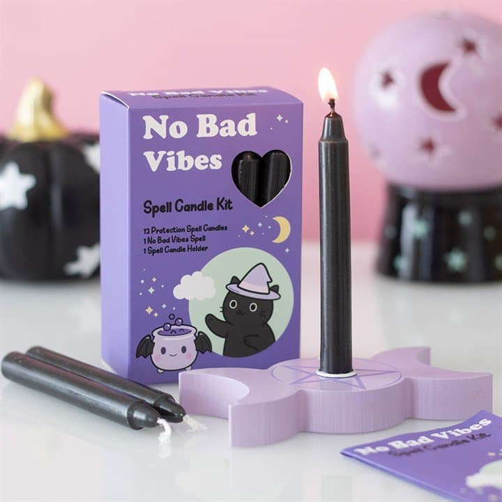 Spell candle kit with black candles, a wooden holder and a spell