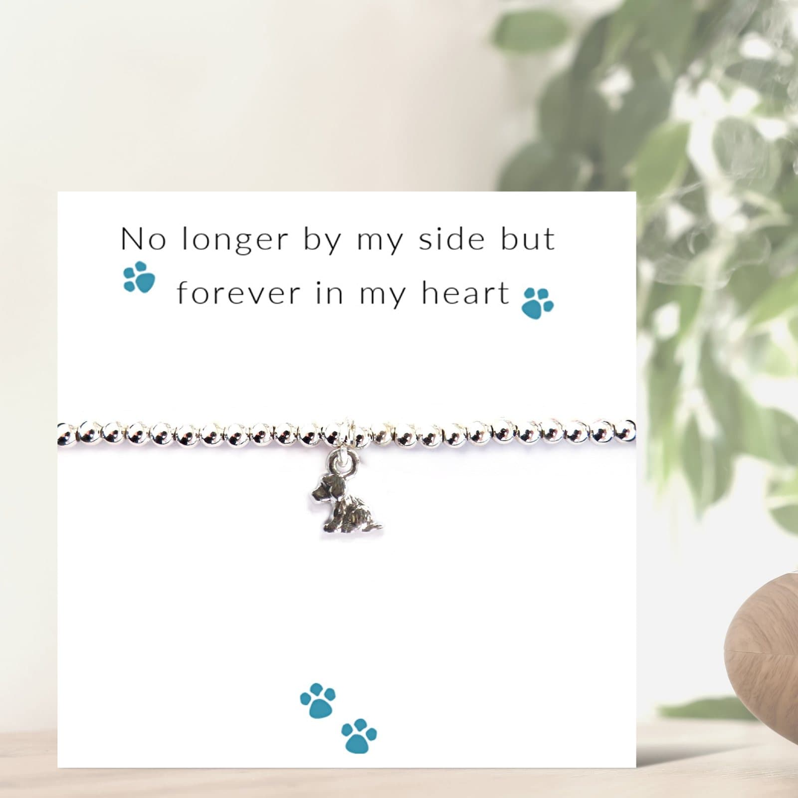 Silver puppy dog charm on a stretch beaded bracelet, presented on a message card