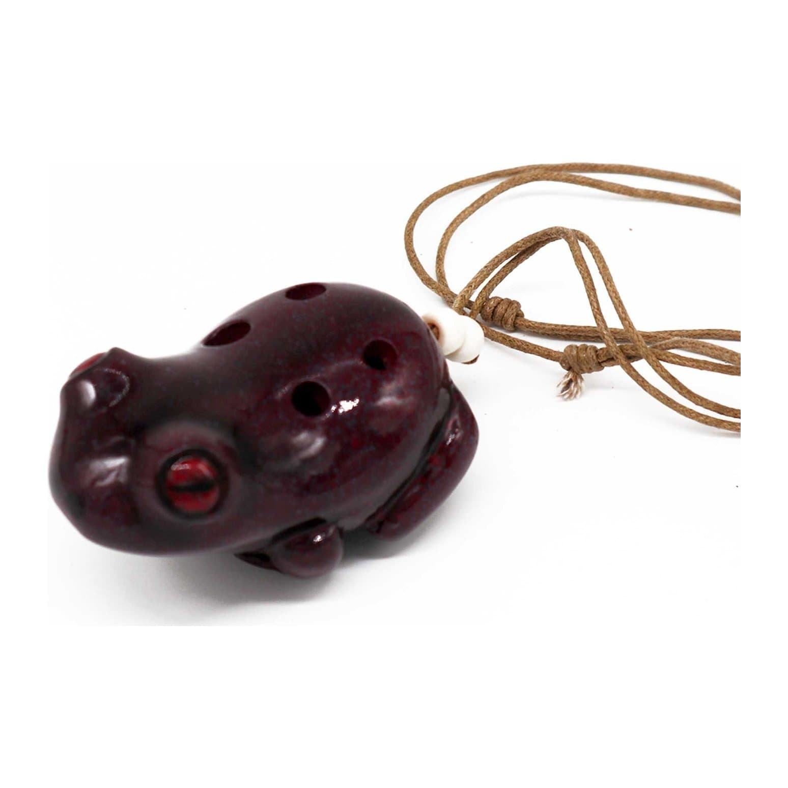 Glossy ceramic frog-shaped ocarina with finger holes and a neck cord