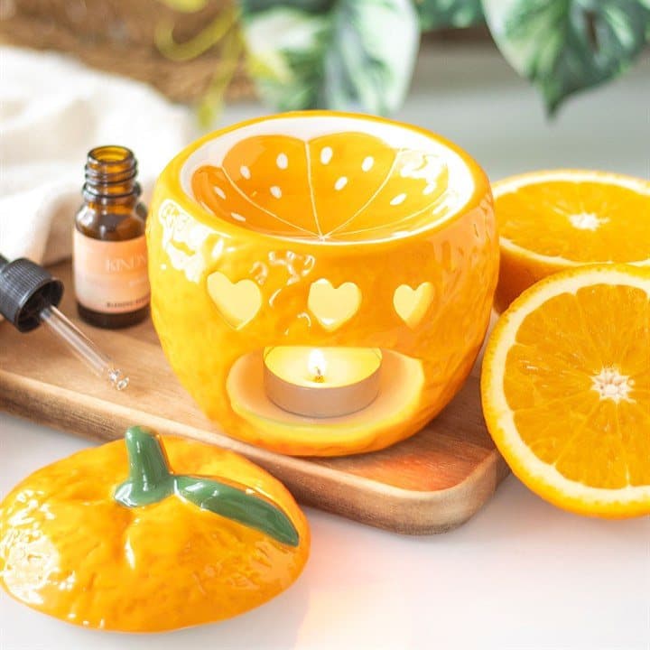 Ceramic orange oil burner with a lid that lifts