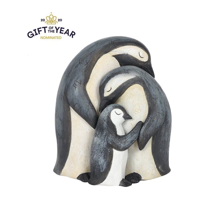 Resin ornament of a penguin family huddled together