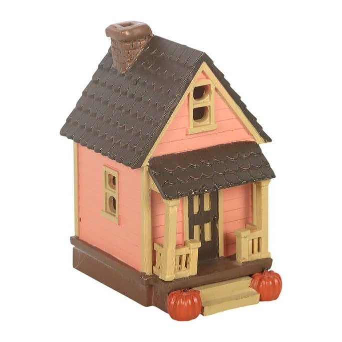 Pink light-up resin house with pumpkins