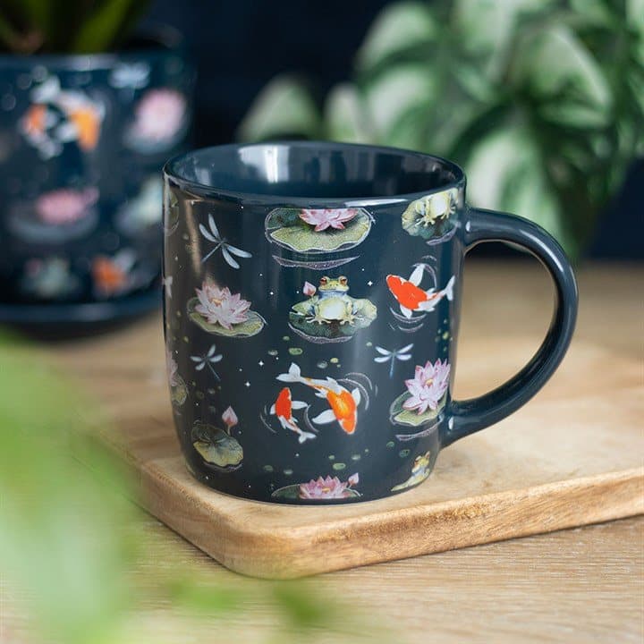Ceramic mug with an all-over print of frogs, lily pads, dragonflies and koi fish