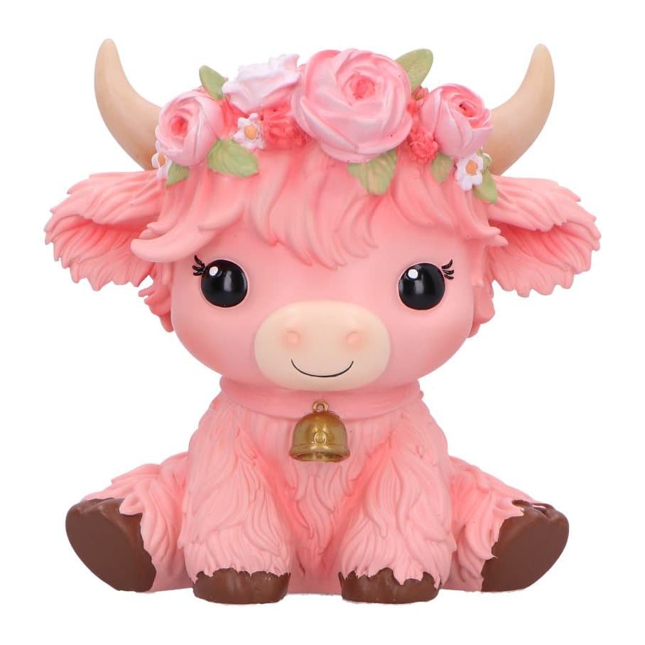 Pink cow figurine sitting with flowers on its head
