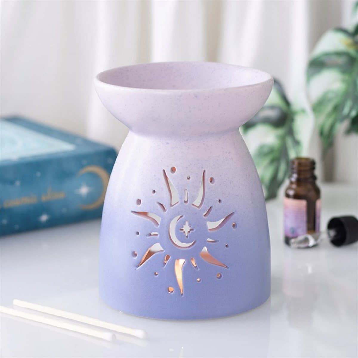 Pastel purple ceramic oil burner with a sun cut-out