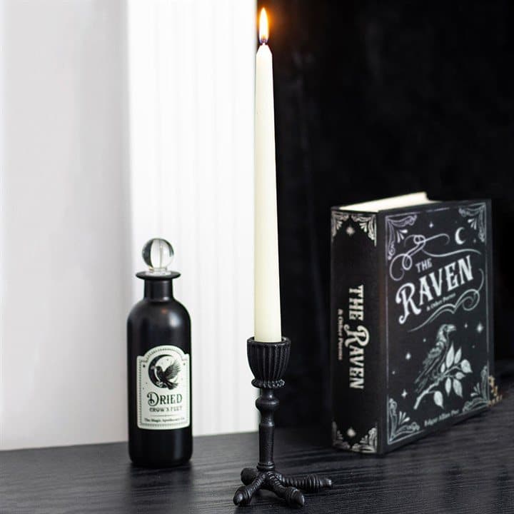 Resin raven claw holding a taper candle