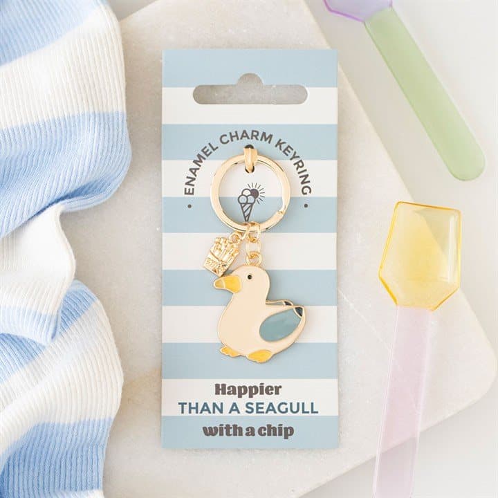 Blue enamel seagull in flight keyring on a cardboard back