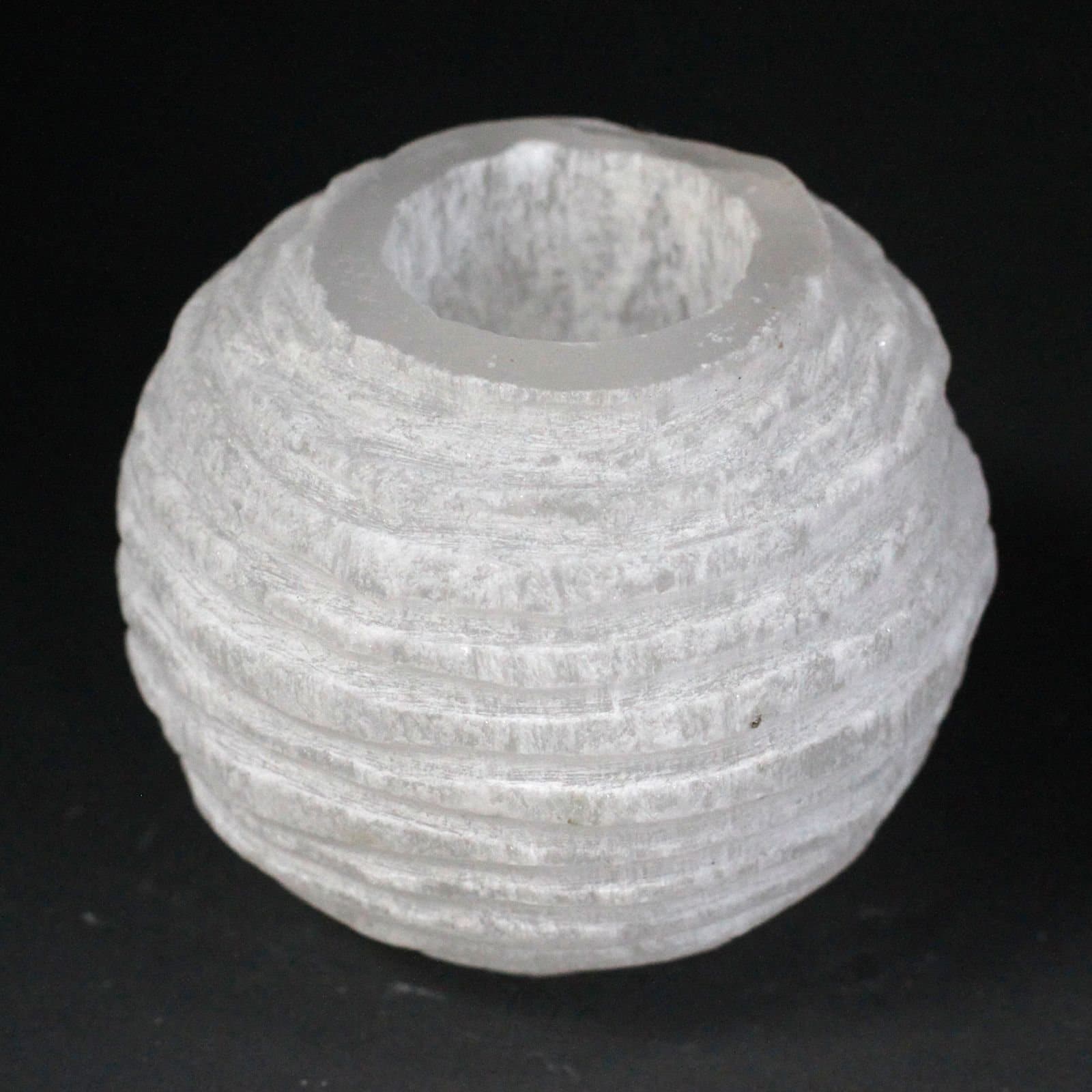 Rounded selenite candle holder in translucent crystal