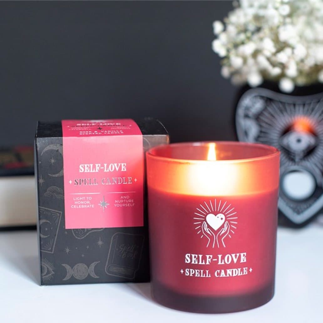 Pink jar candle with heart-in-hands artwork