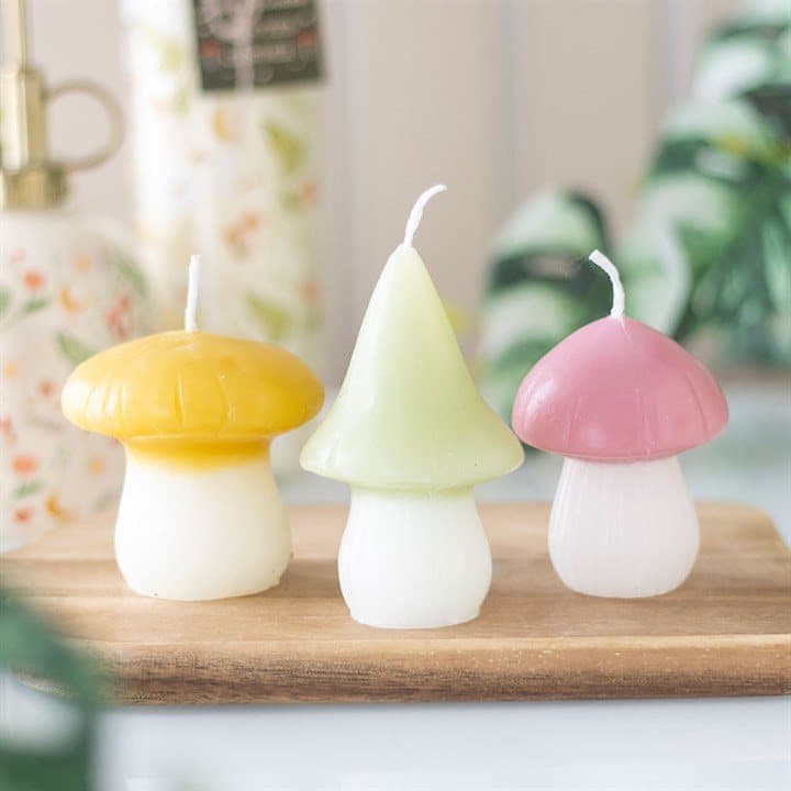 Set of three pastel mushroom-shaped candles
