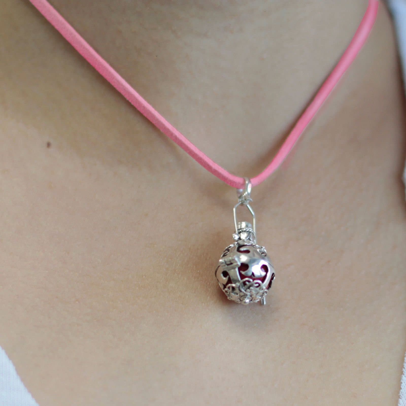 Small 16 mm silver angel bell on a neck cord