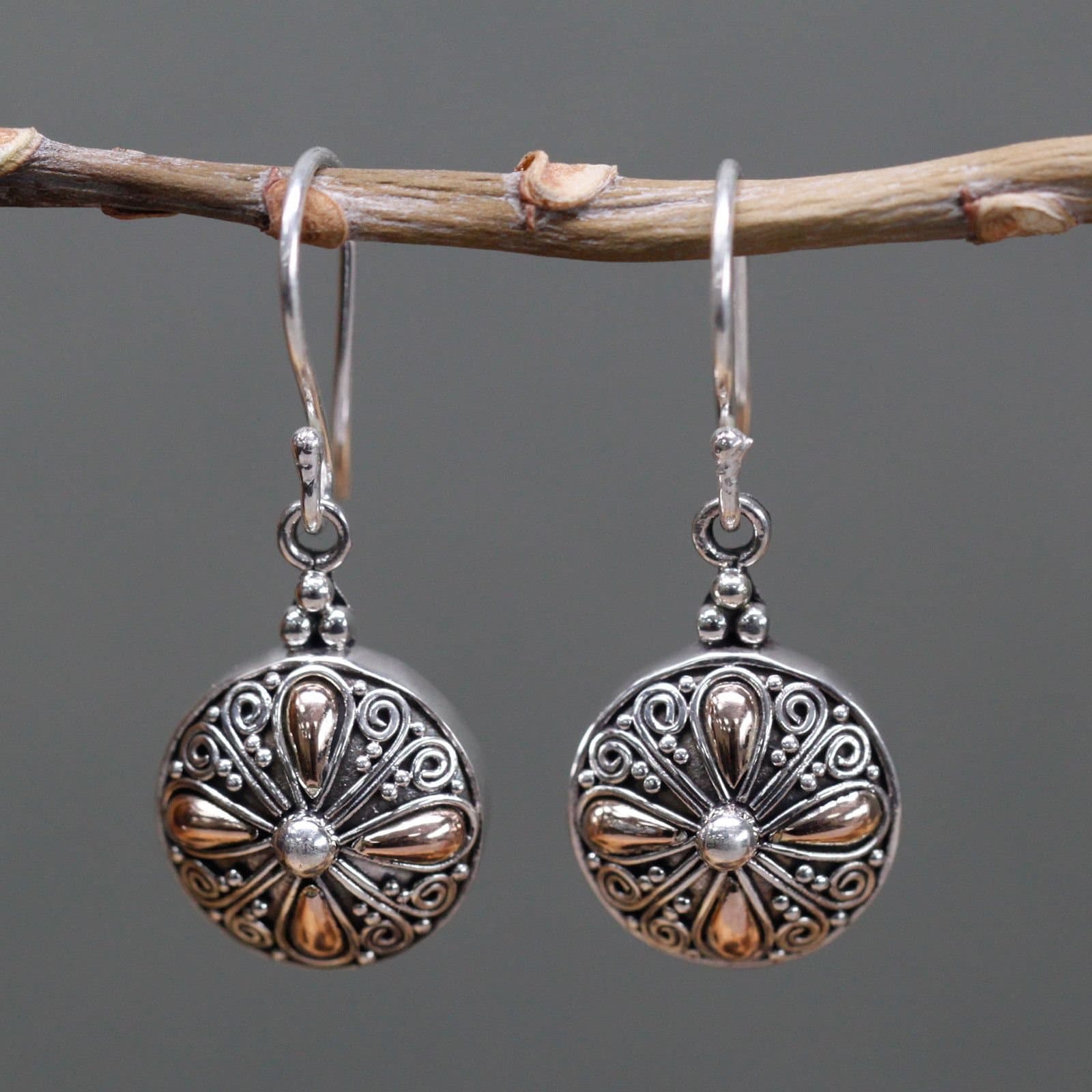 Classic round silver and gold earring with a hook fitting