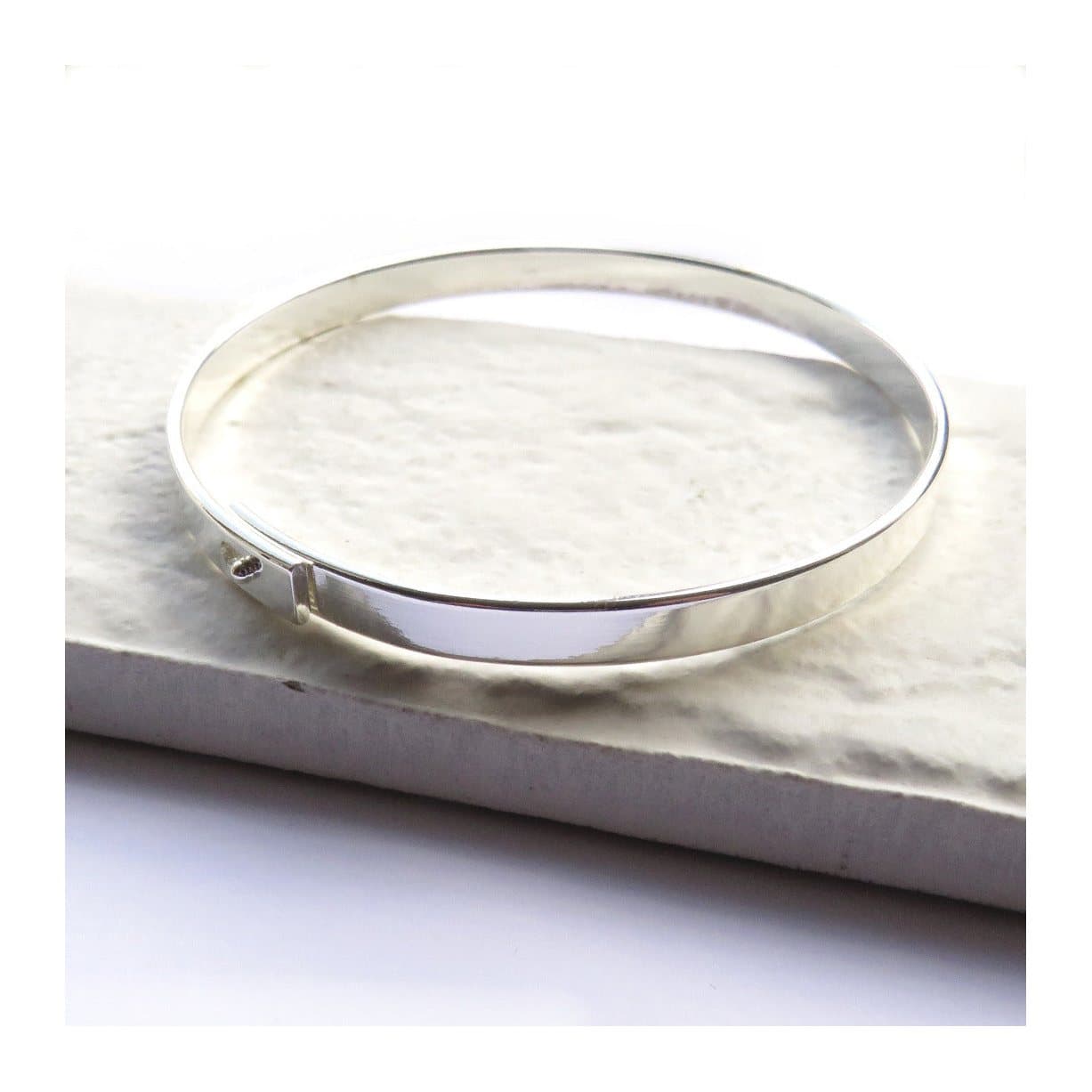 A slim silver thin bangle, 5 mm wide.