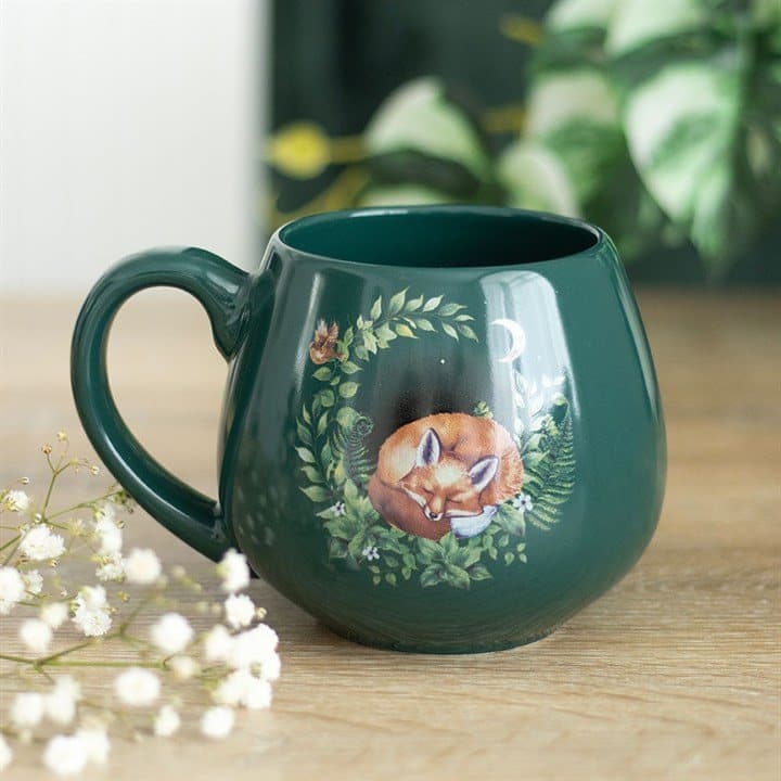Green mug with a sleeping fox