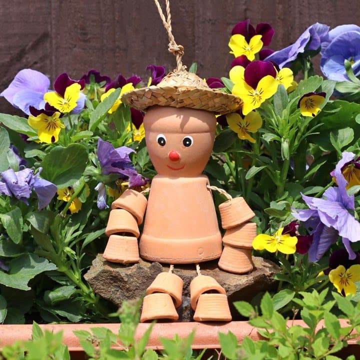 Small terracotta pot man wearing a straw hat