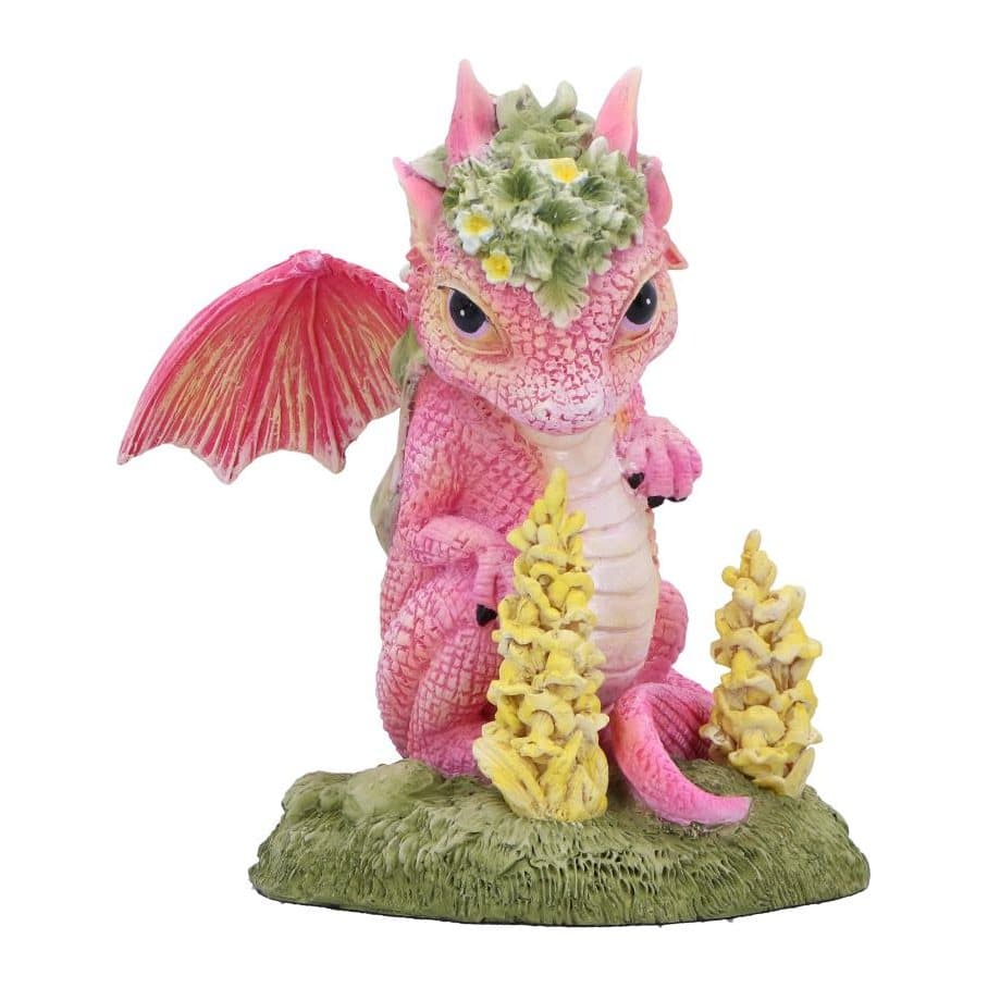 Pink dragon figurine with gold-streaked wings and green and white snapdragon flowers