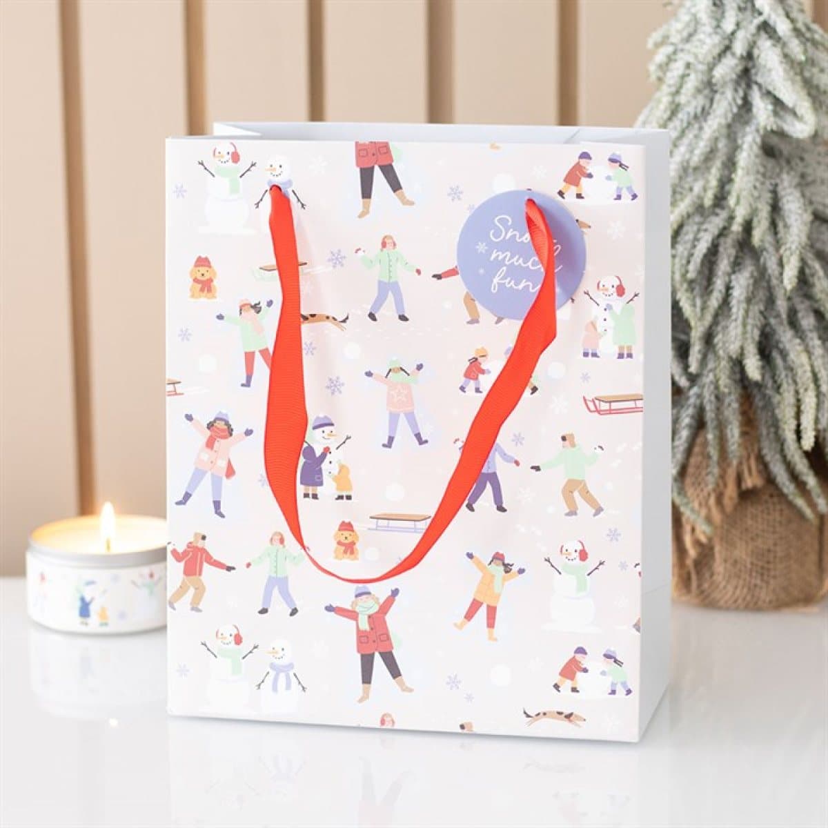Snow Much Fun print Christmas gift bag with a playful winter design