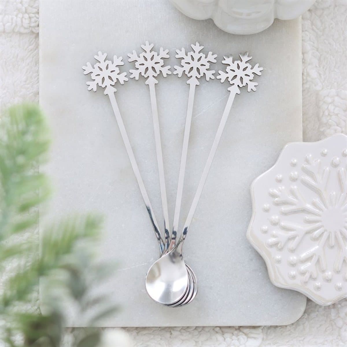 Set of four metal snowflake spoons
