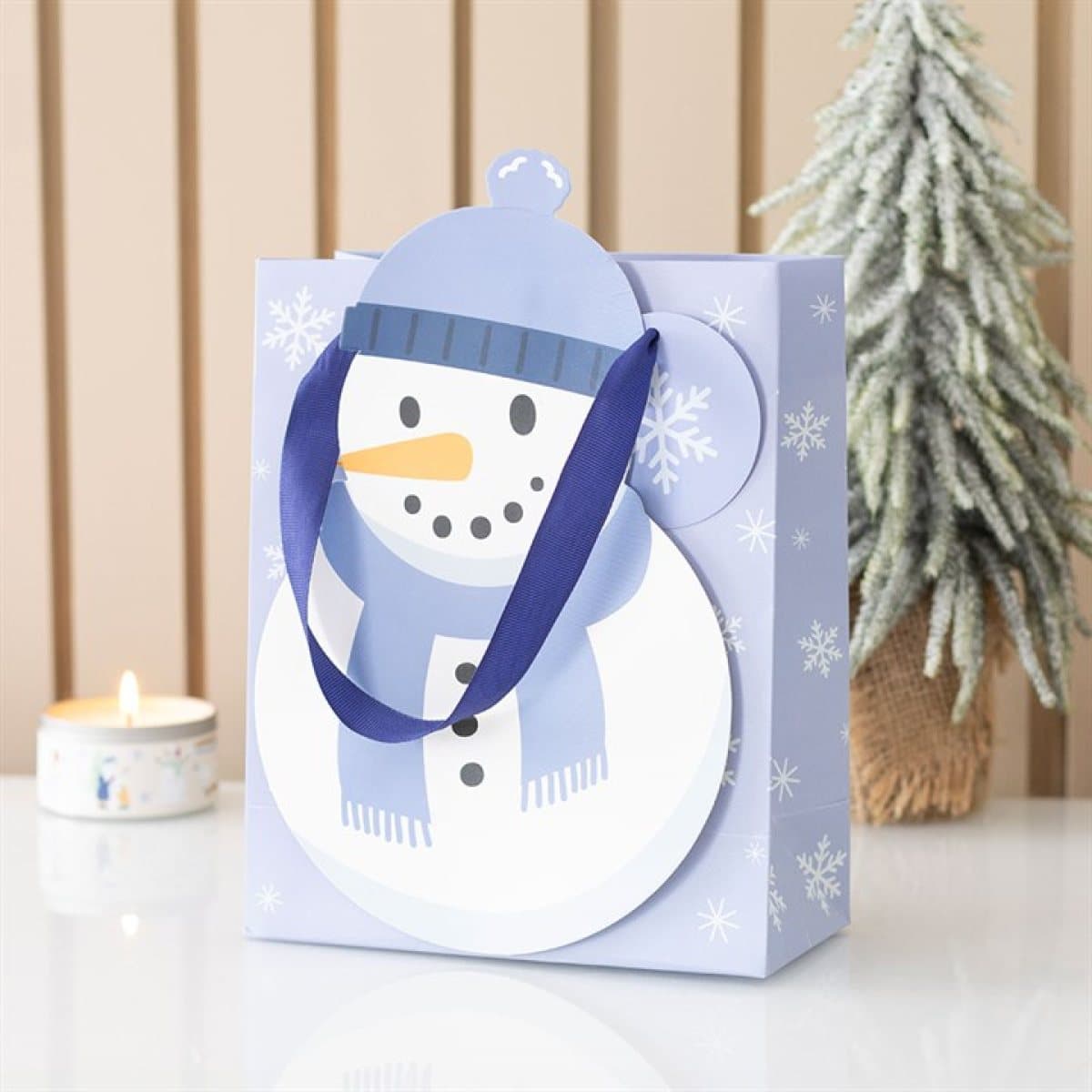 Paper gift bag shaped like a snowman with a winter character design