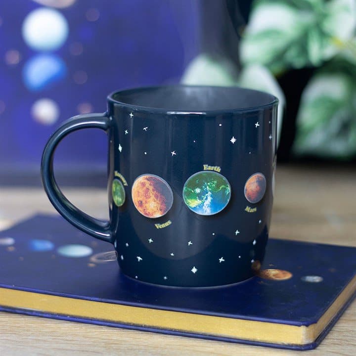 Black ceramic mug with a solar system and stars design