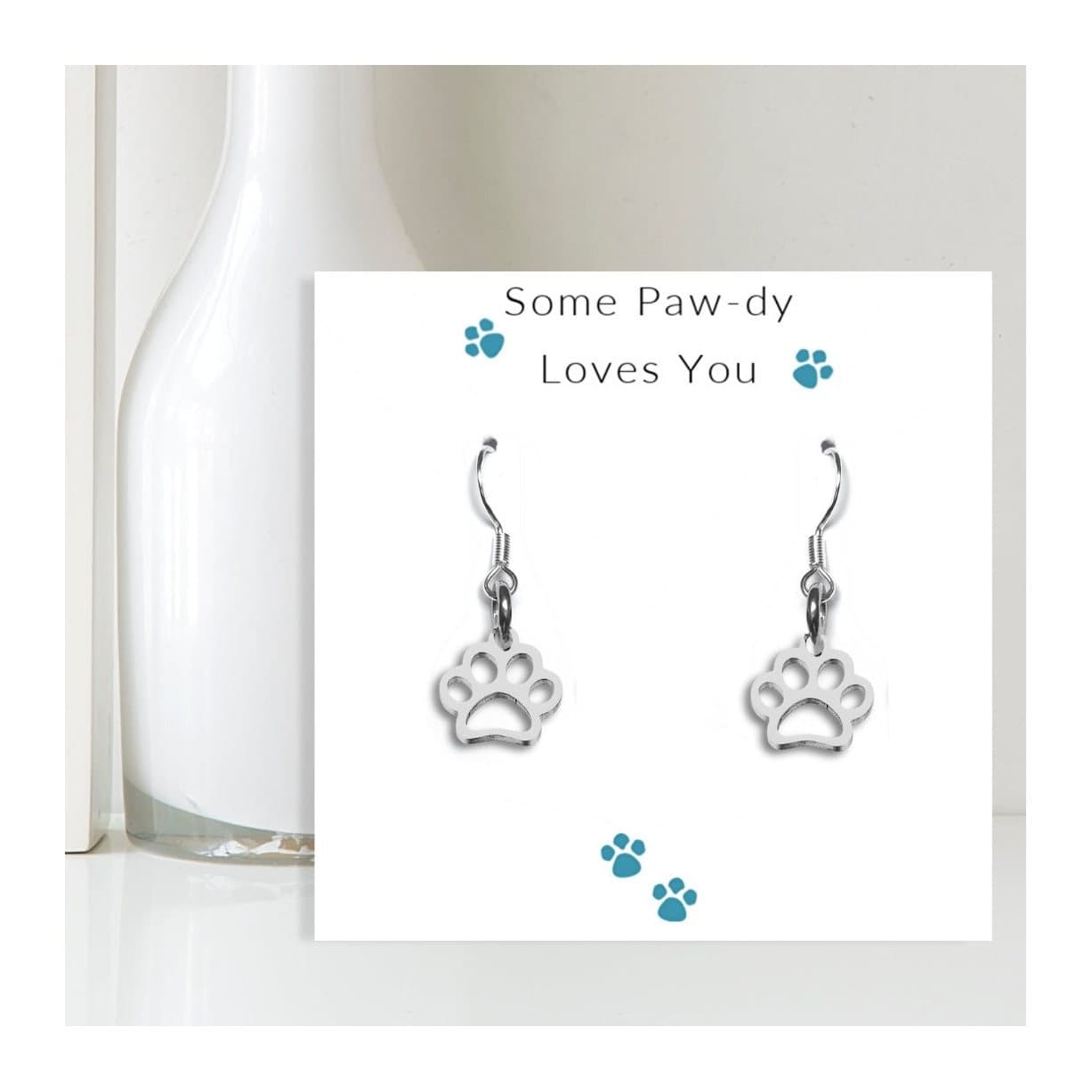 Silver paw print charm earrings with a Some Paw-dy Loves You message card