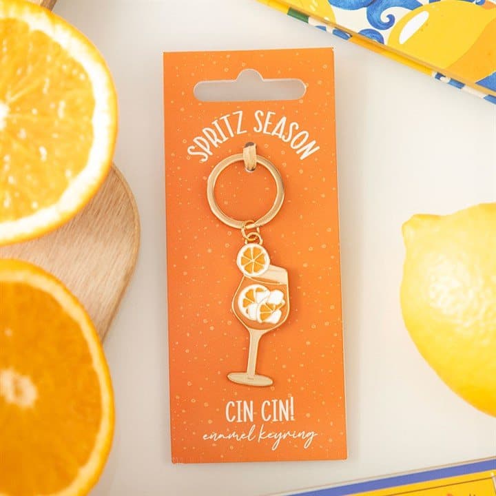 Colourful Spritz Season enamel keyring on a cardboard back