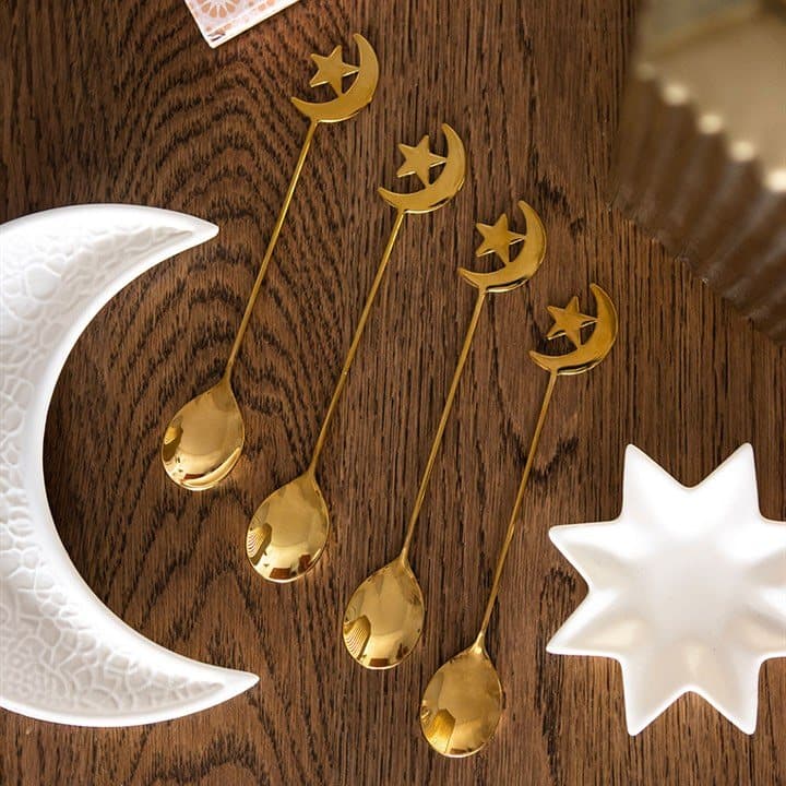 Four golden teaspoons with moon and star handles