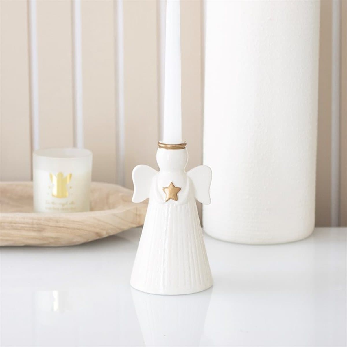 Off-white ceramic angel candle holder with a gold star