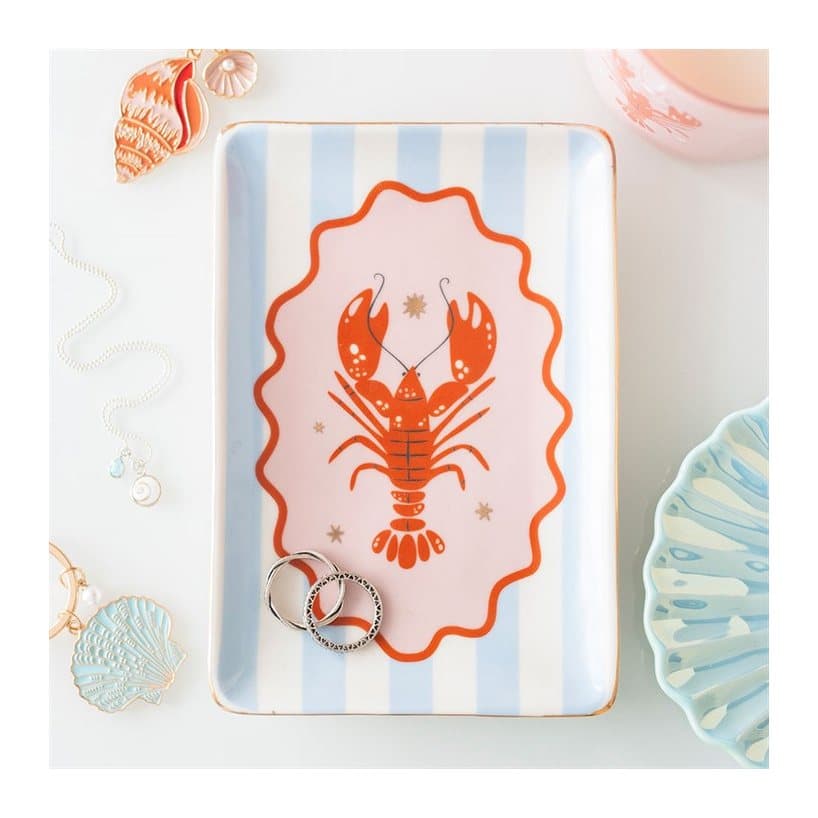 Pastel ceramic trinket dish with a red lobster on blue stripes