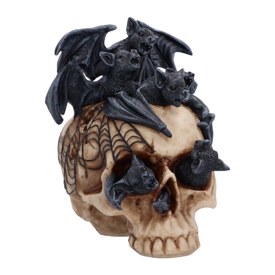 Skull figurine covered in bats, with bats emerging from the eyes and nose