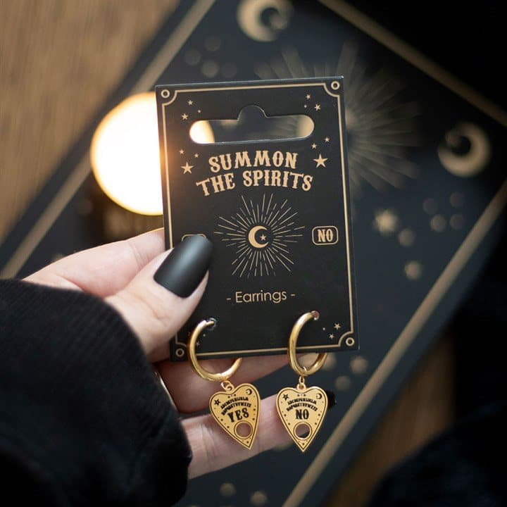 Pair of gold-tone talking board planchette earrings on a matching backing card